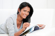 Young woman reading magazine