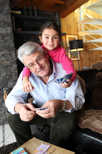 Photo: Little girl playing cards with grandpa Little girl playing cards with grandpa
