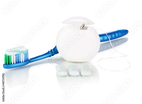 Photo: Toothbrush, chewing gum and dental floss isolated on white Toothbrush, chewing gum and dental floss isolated on white