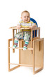 Baby sitting in highchair.