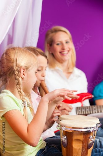 Photo: Family making music at home Family making music at home