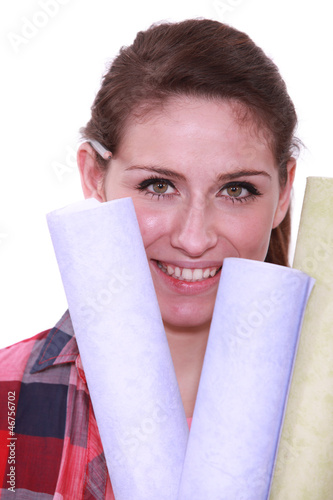 Photo: Woman holding selection of wallpaper Woman holding selection of wallpaper