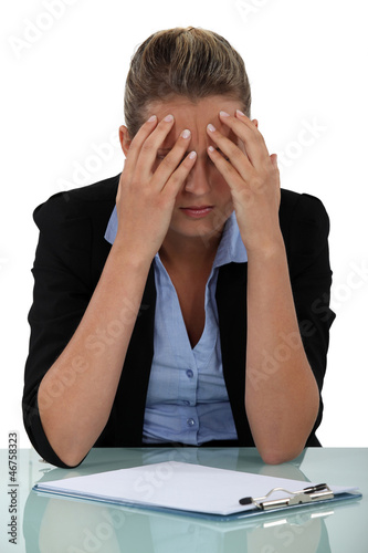 Photo: Stressed young office worker with clip board Stressed young office worker with clip board