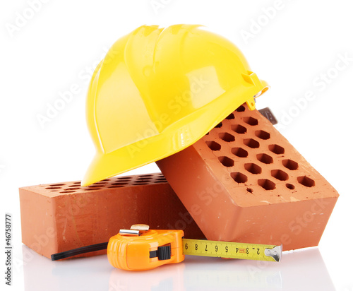Photo: helmet, roulette and bricks isolated on white helmet, roulette and bricks isolated on white