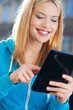 Woman using digital tablet outdoors