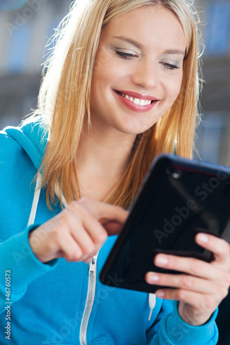 Photo: Woman using digital tablet outdoors Woman using digital tablet outdoors