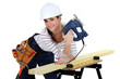 Young woman using a jigsaw