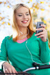 Woman on bike with mobile phone