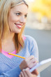 Woman with notebook and pencil