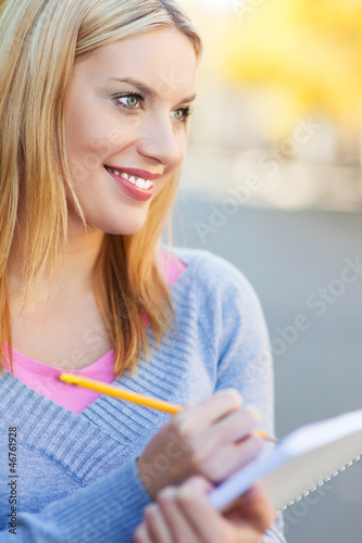 Photo: Woman with notebook and pencil Woman with notebook and pencil