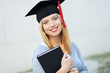 Female graduate holding book