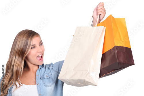 Photo: Blond woman stood holding shopping bags Blond woman stood holding shopping bags