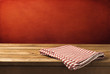 Background with wooden table, tablecloth and  grunge red wall