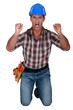 craftsman kneeling and raising his hands