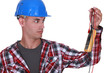 Wide-eyed tradesman staring at a multimeter