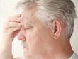 man with headache over eye