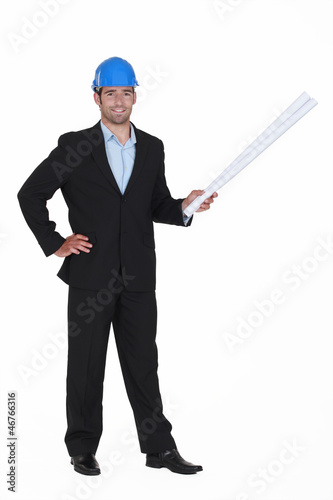 Photo: Successful architect stood with rolled up blueprints Successful architect stood with rolled up blueprints