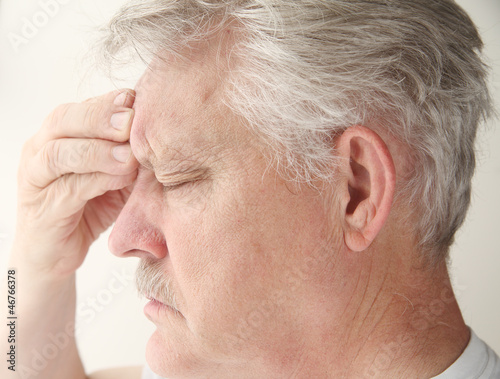 Photo: man with headache over eye man with headache over eye