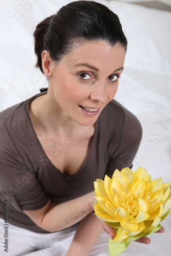 Photo: Woman holding a flower Woman holding a flower