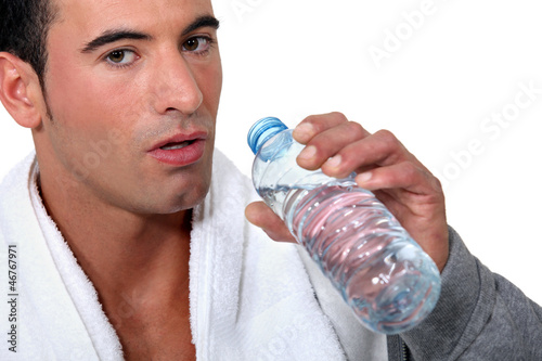 Photo: Man drinking from bottle of water Man drinking from bottle of water
