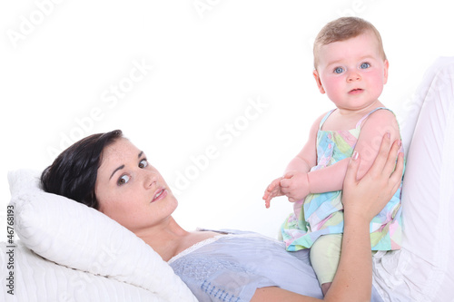 Photo: young mother with baby in bed young mother with baby in bed