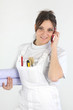 Female decorator holding rolls of wallpaper