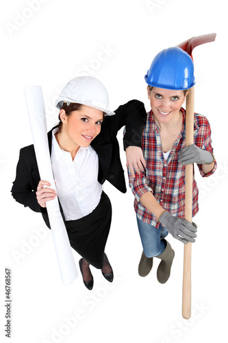 Photo: High-angle shot of a tradeswoman standing next to an engineer High-angle shot of a tradeswoman standing next to an engineer