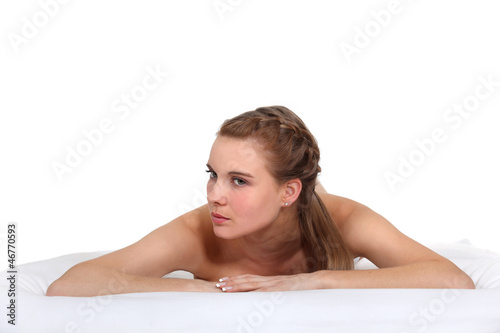Photo: Woman laying naked in studio Woman laying naked in studio