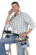 Photo: Carpenter posing by ladder Carpenter posing by ladder