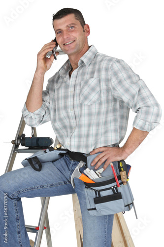 Photo: Carpenter posing by ladder Carpenter posing by ladder