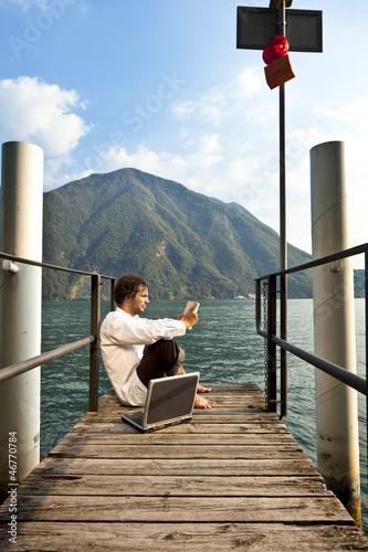 Photo: portrait of young man on the dock of Lake portrait of young man on the dock of Lake