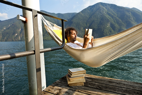 Photo: portrait of young man on the dock of Lake portrait of young man on the dock of Lake