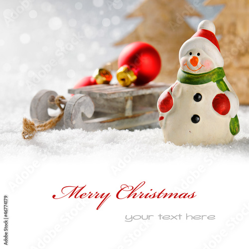 Photo: Christmas snowman with presents in winter forest Christmas snowman with presents in winter forest