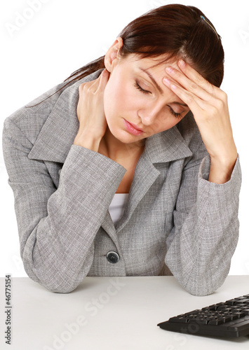 Photo: A tired woman sitting on the desk A tired woman sitting on the desk