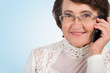 Photo: Senior woman talking on mobile phone Senior woman talking on mobile phone