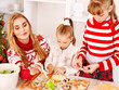 Children rolling dough in kitchen.