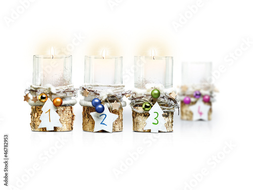 Photo: Third Advent Candle on white background Third Advent Candle on white background
