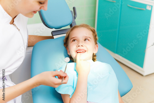 Photo: Little girl visiting dentist Little girl visiting dentist