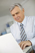 Senior businessman working on laptop computer