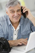 Photographer in office talking to client on the phone