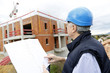 Construction manager checking building project on site