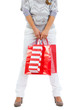 Closeup on woman standing with red shopping bags