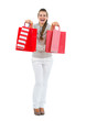 Happy woman in sweater with red shopping bags