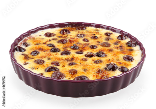 Photo: cream brulee with cherries isolated on white with clipping path cream brulee with cherries isolated on white with clipping path