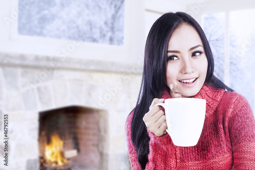 Photo: Attractive young woman enjoy coffee at home Attractive young woman enjoy coffee at home