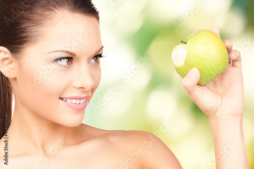 Photo: young beautiful woman with green apple young beautiful woman with green apple