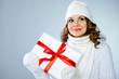 Photo: Beautiful young girl holding present box with red ribbon Beautiful young girl holding present box with red ribbon