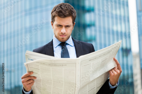 Photo: Man reading a newspaper Man reading a newspaper