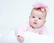 Portrait of a baby girl with a flower on her head on a white bac
