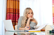 attractive woman writing on laptop